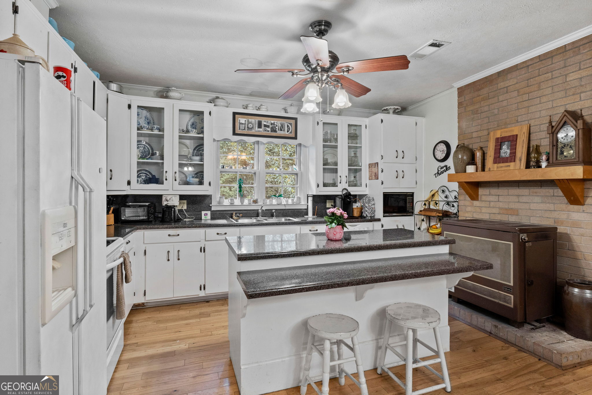 2037 Jeff Davis Road Thomaston, GA 30286 - Photo 14 of 60 a kitchen with stainless steel appliances kitchen island granite countertop a stove a sink and a refrigerator