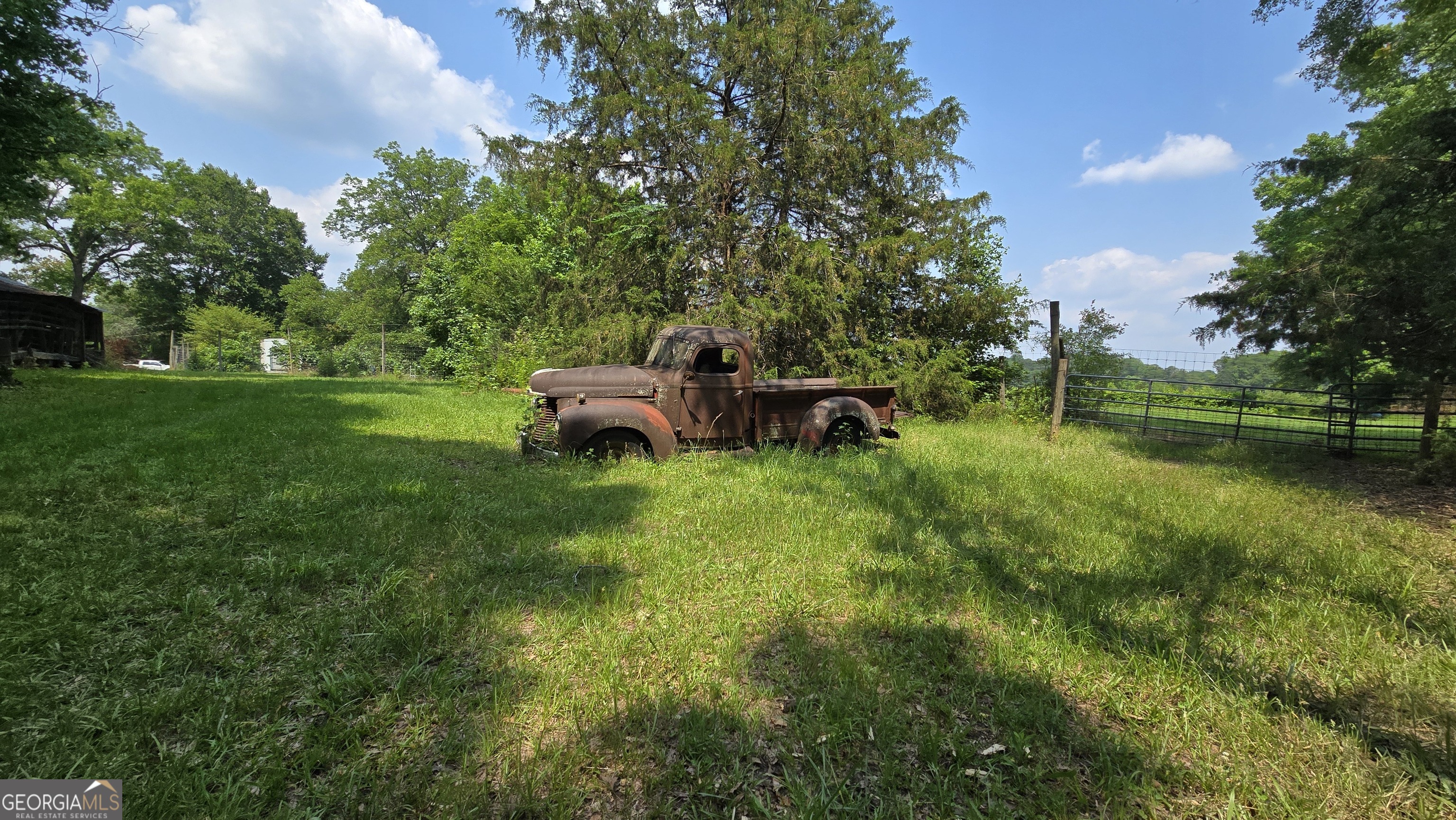 2037 Jeff Davis Road Thomaston, GA 30286 - Photo 38 of 60 a view of a backyard with table and chairs and a fire pit