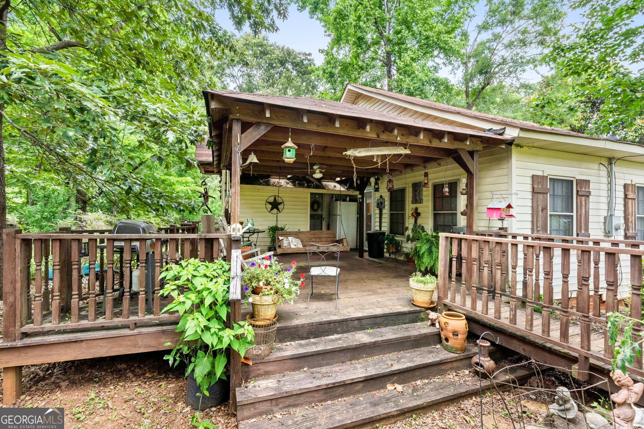 2037 Jeff Davis Road Thomaston, GA 30286 - Photo 8 of 60 a view of a chair and tables in the patio in front of the house
