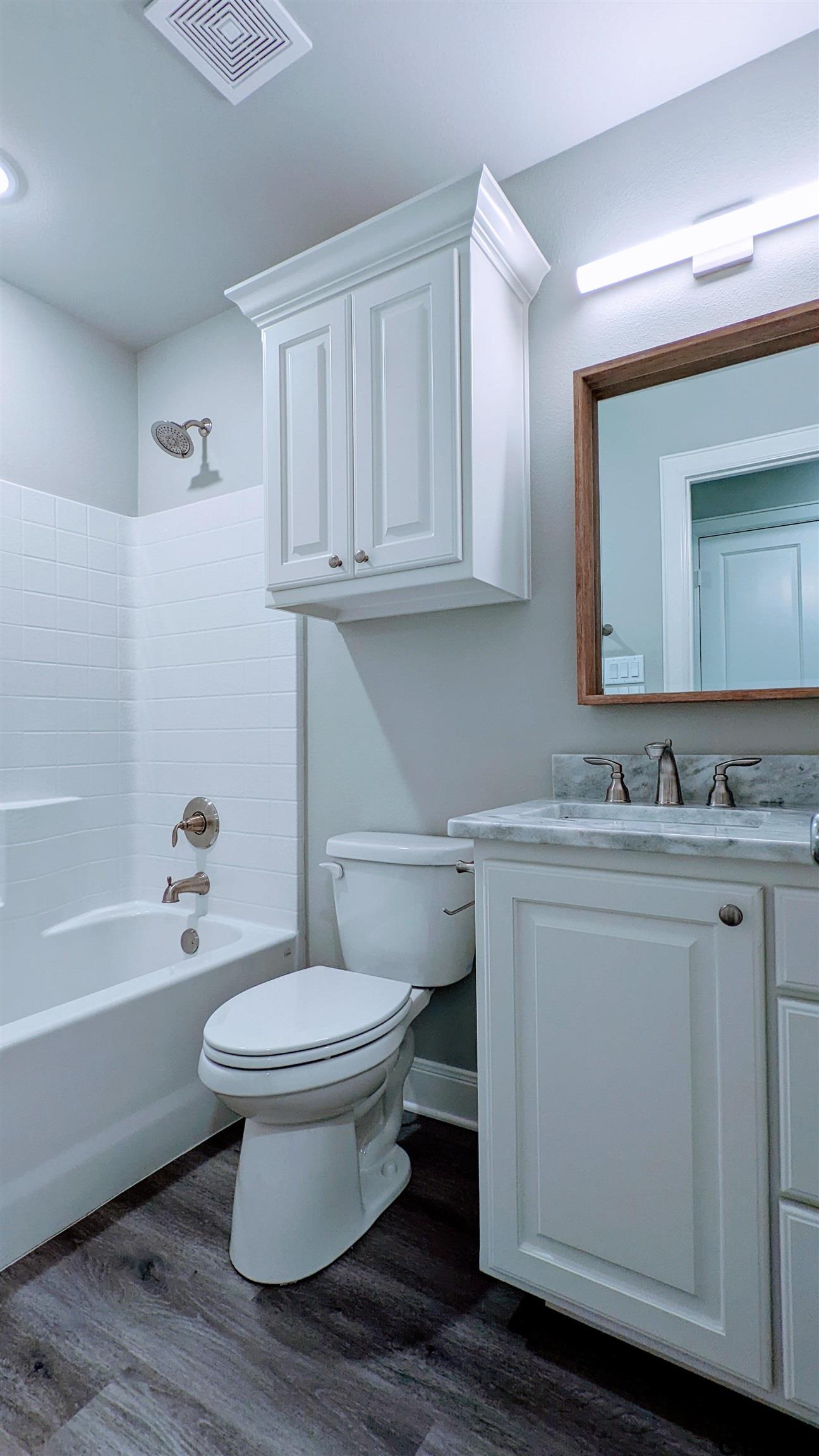 11672 Fm 2015, Unit B Tyler, TX 75708 - Photo 11 of 16 a bathroom with a sink toilet a mirror and bathtub