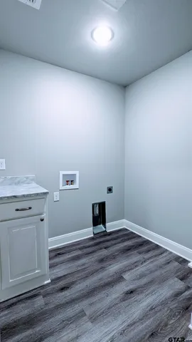 a view of a room with wooden floor