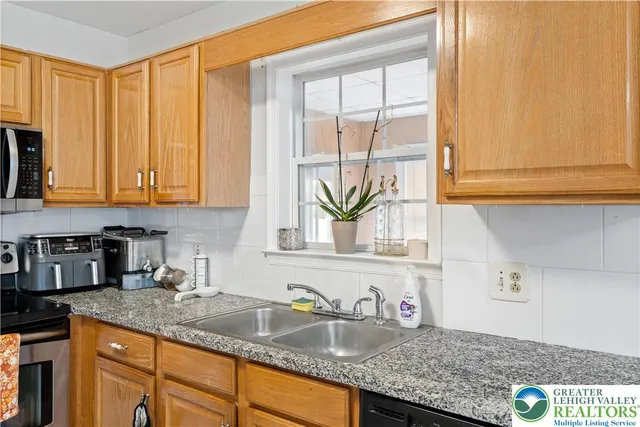 a view of entryway with workspace and a window