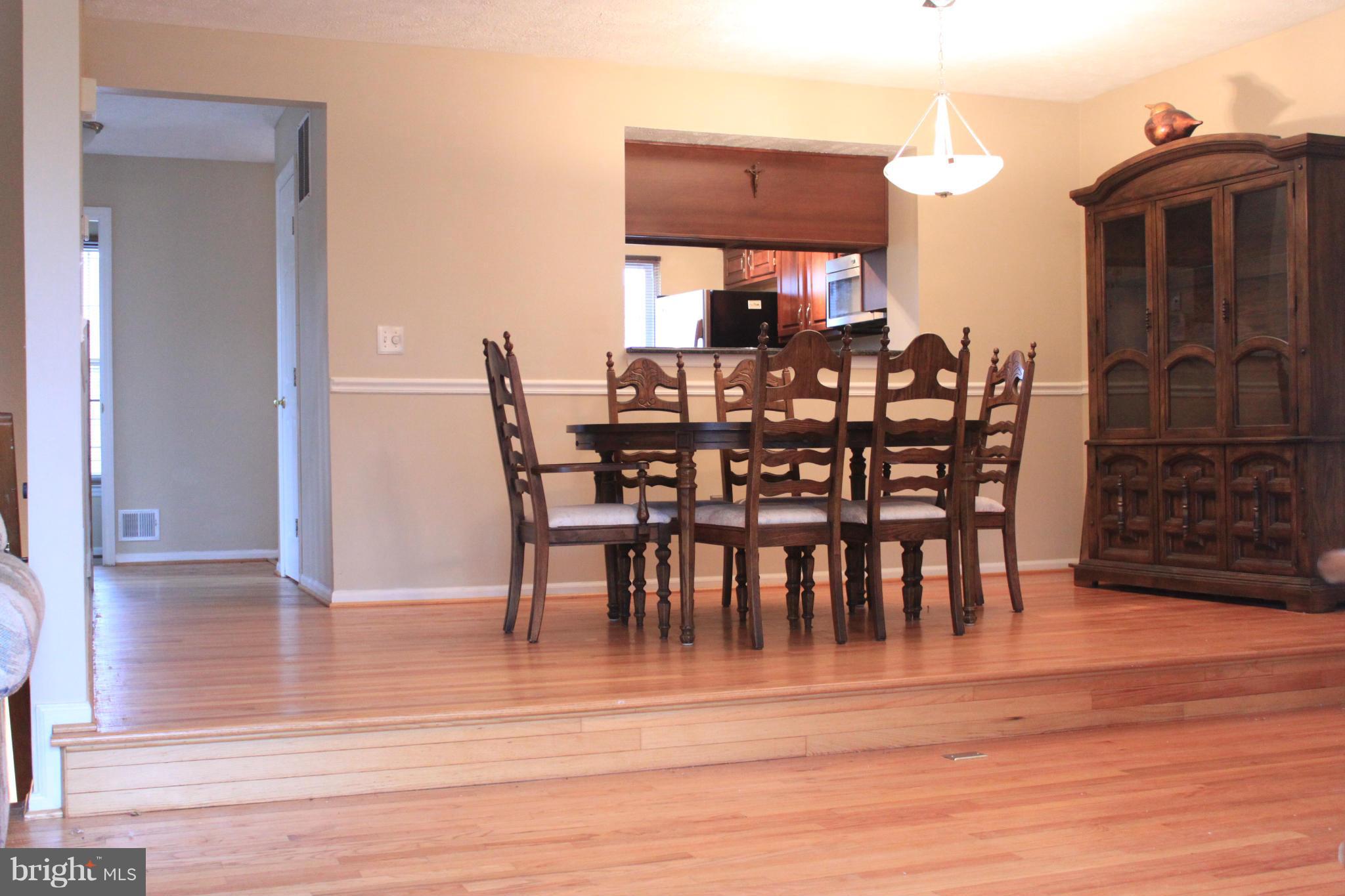 44001 Choptank Terrace Ashburn, VA 20147 - Photo 3 of 11 a view of a dining room with furniture and wooden floor