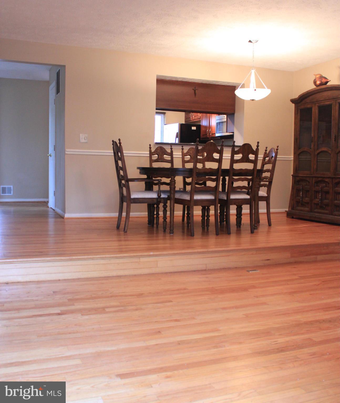 44001 Choptank Terrace Ashburn, VA 20147 - Photo 4 of 11 a view of a dining room with furniture and wooden floor