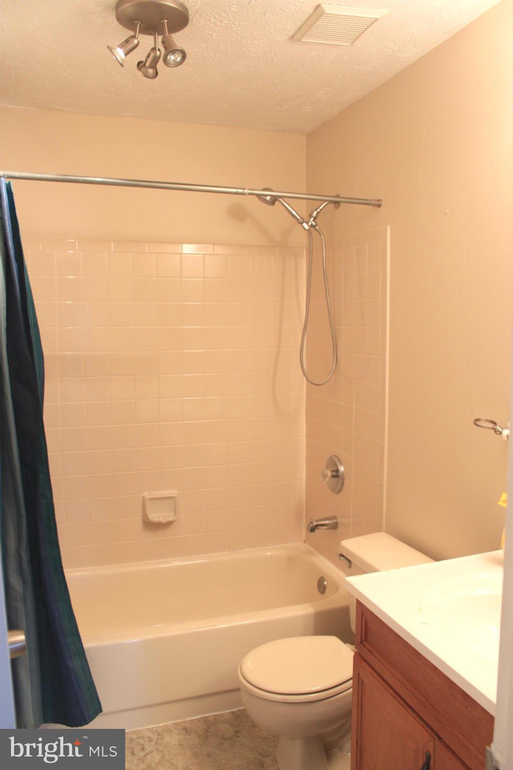 44001 Choptank Terrace Ashburn, VA 20147 - Photo 7 of 11 a bathroom with a granite countertop bathtub shower sink vanity and toilet