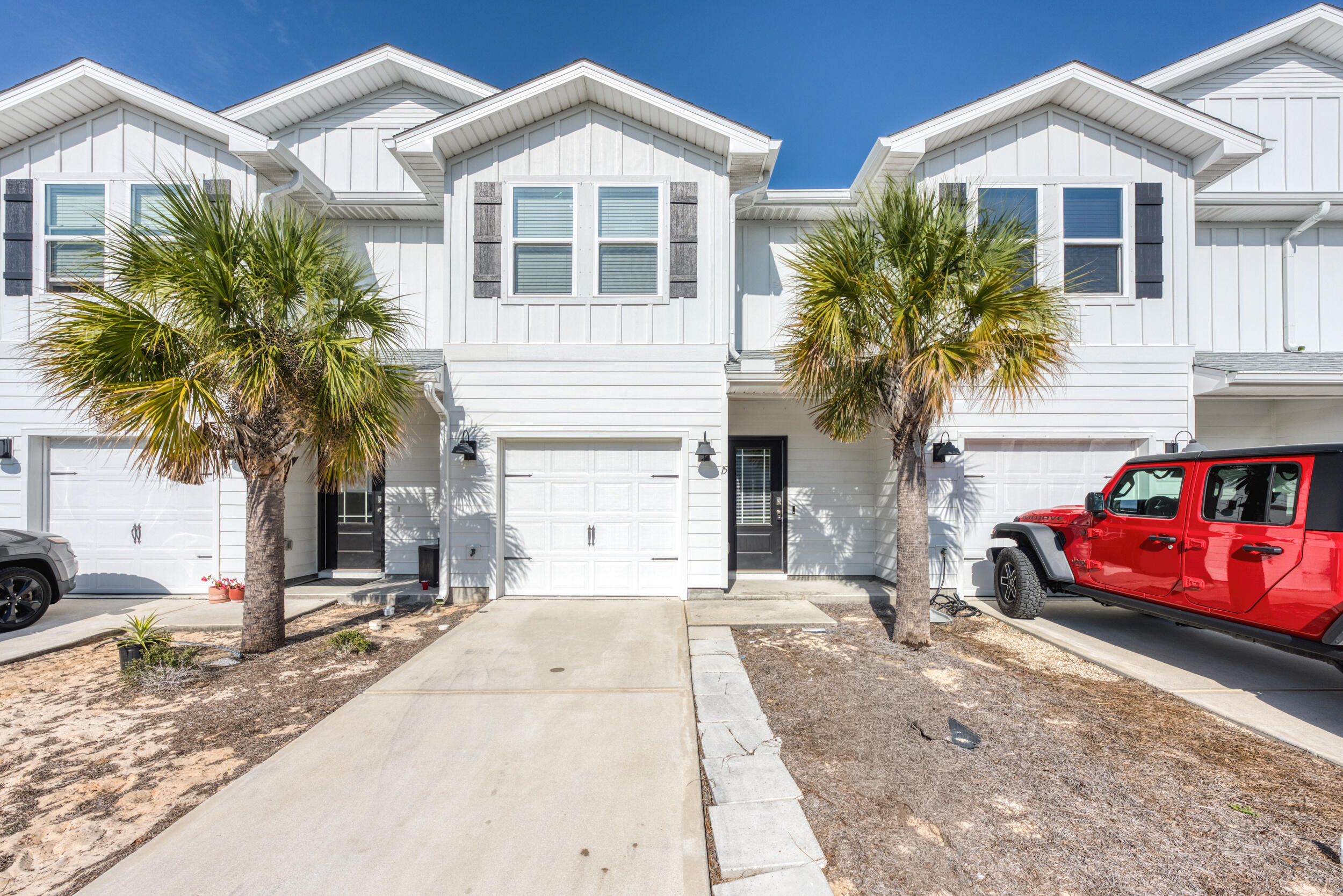 a front view of house with yard and car parked