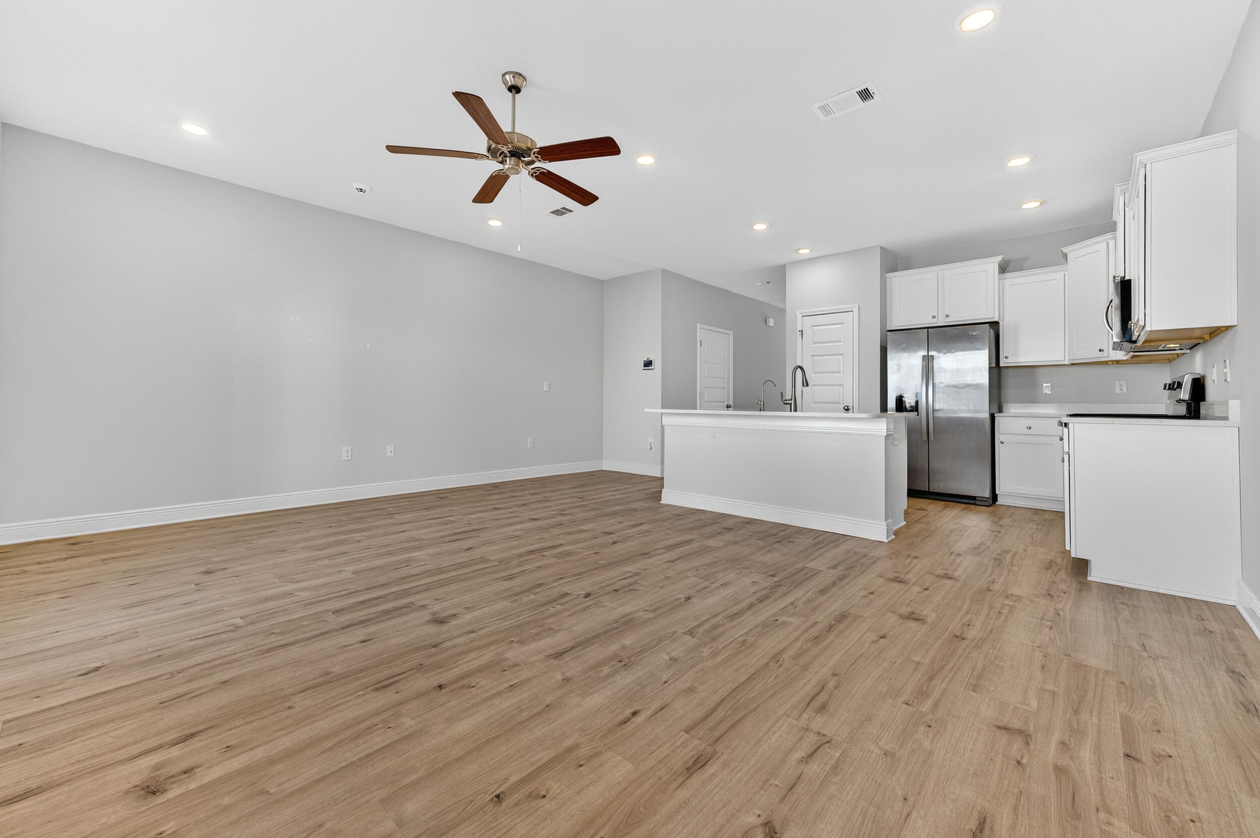 15 Redbird Loop Destin, FL 32541 - Photo 11 of 42 a view of empty room with wooden floor and window