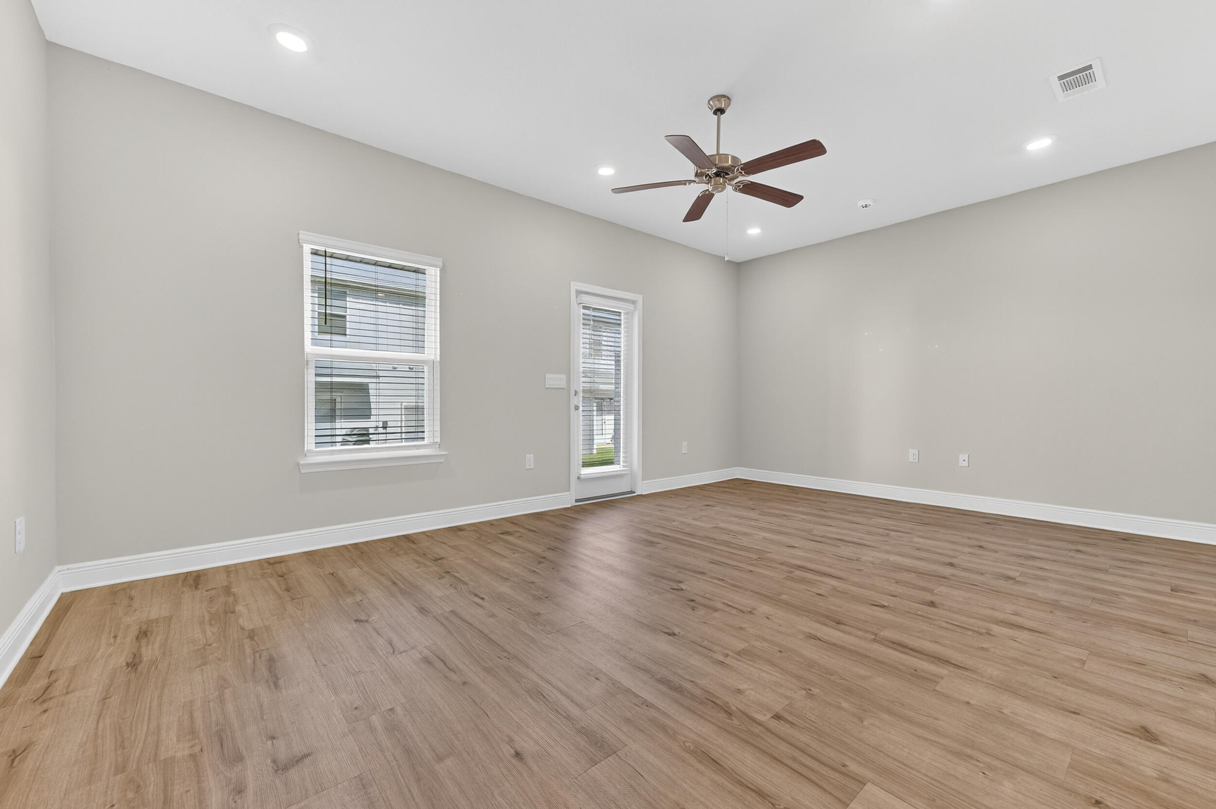15 Redbird Loop Destin, FL 32541 - Photo 12 of 42 wooden floor in an empty room with a window