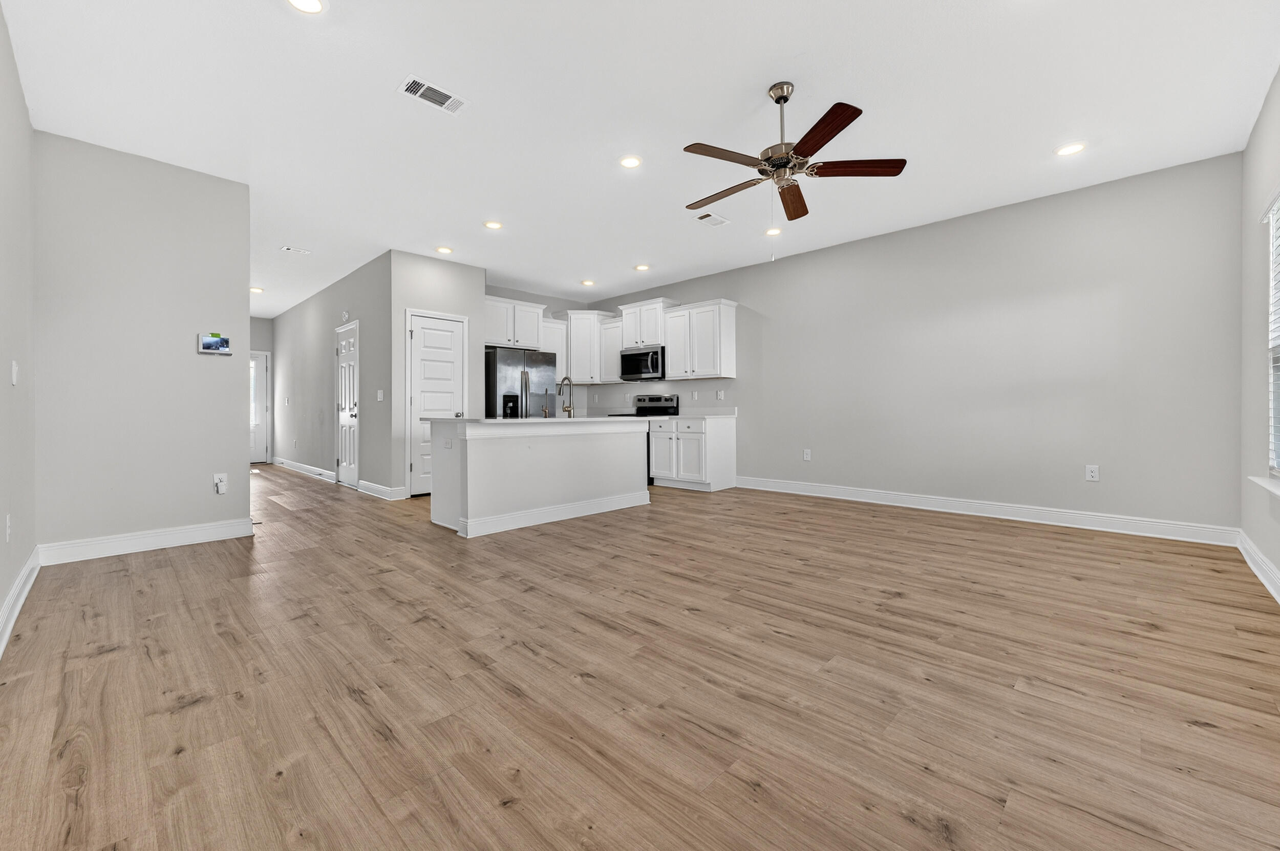 15 Redbird Loop Destin, FL 32541 - Photo 13 of 42 a view of a livingroom with kitchen appliances and a ceiling fan