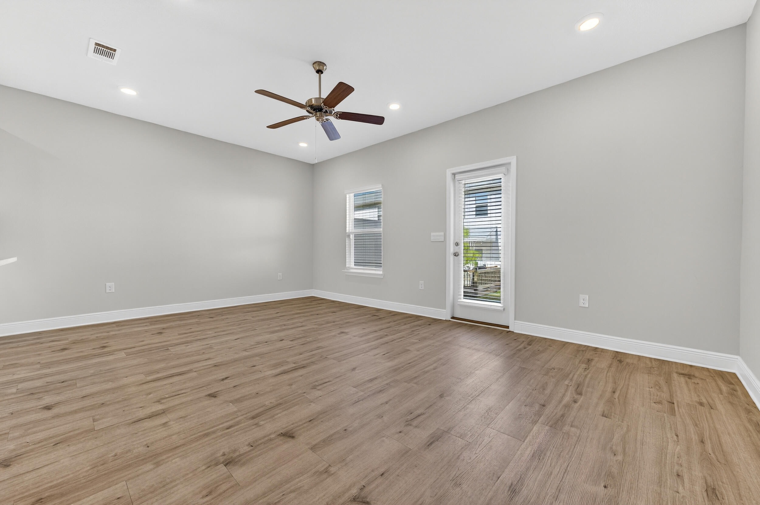 15 Redbird Loop Destin, FL 32541 - Photo 14 of 42 a view of an empty room with wooden floor and a window