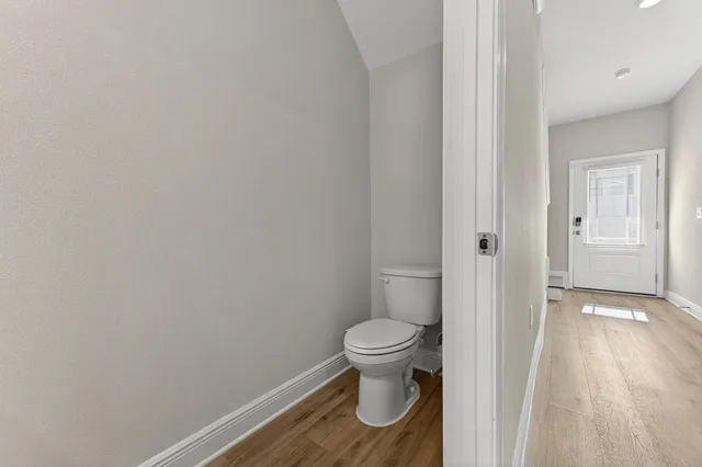 a bathroom with a toilet and a shower