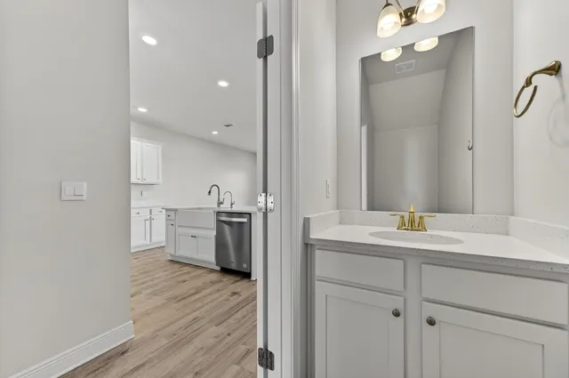 a view of a kitchen from the hallway with a sink