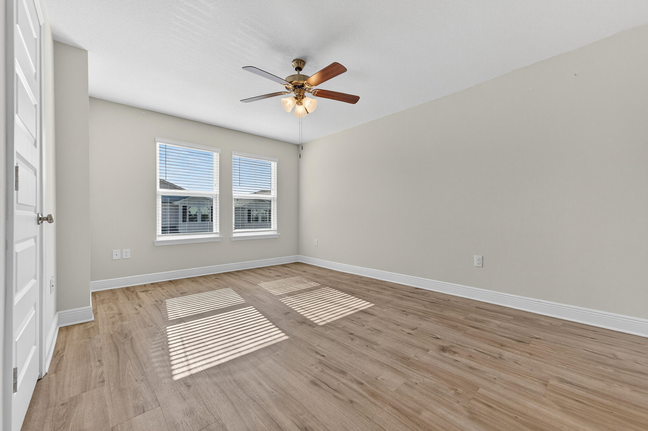 15 Redbird Loop Destin, FL 32541 - Photo 19 of 42 a view of an empty room with wooden floor and a window