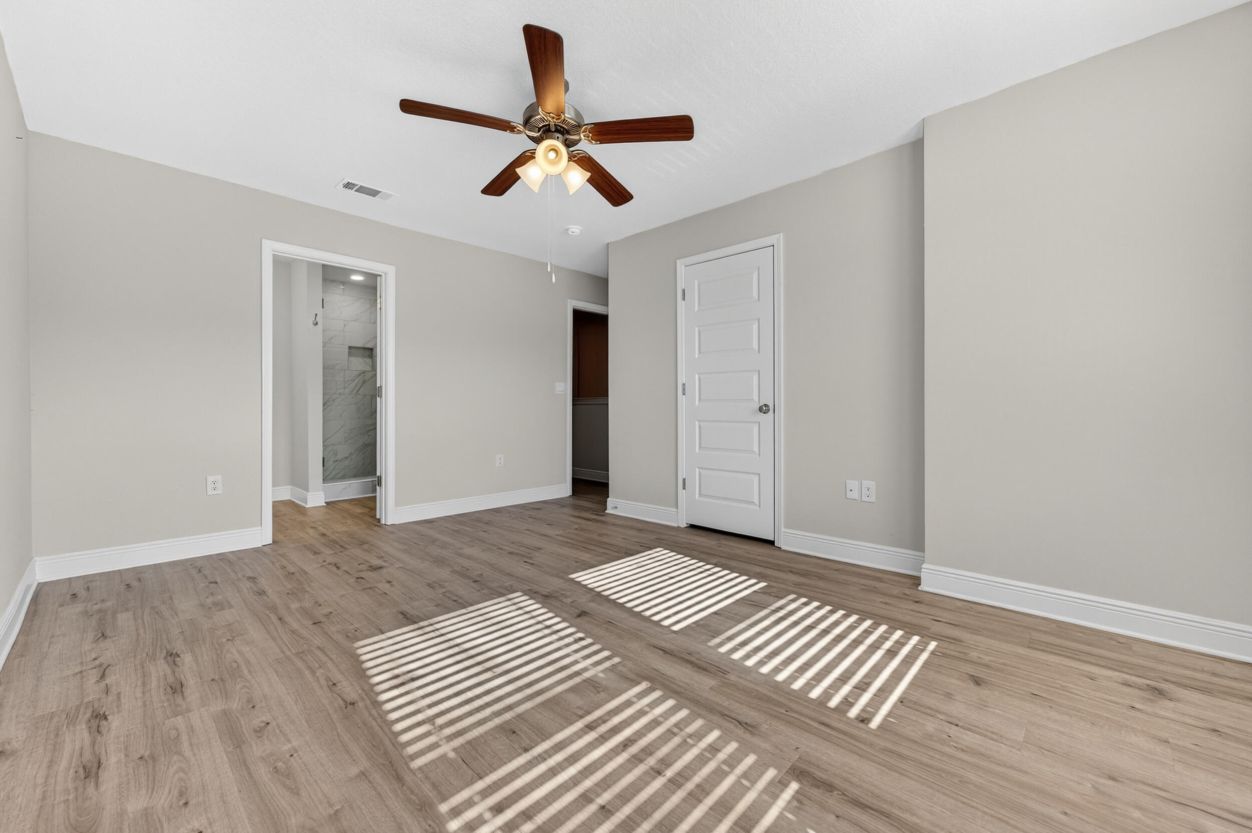 15 Redbird Loop Destin, FL 32541 - Photo 21 of 42 a view of an empty room with wooden floor ceiling fan