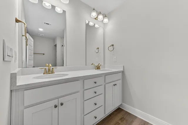a bathroom with a double vanity sink and a mirror