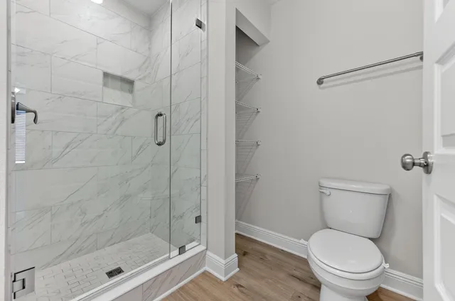 a a bathroom with a toilet and a shower