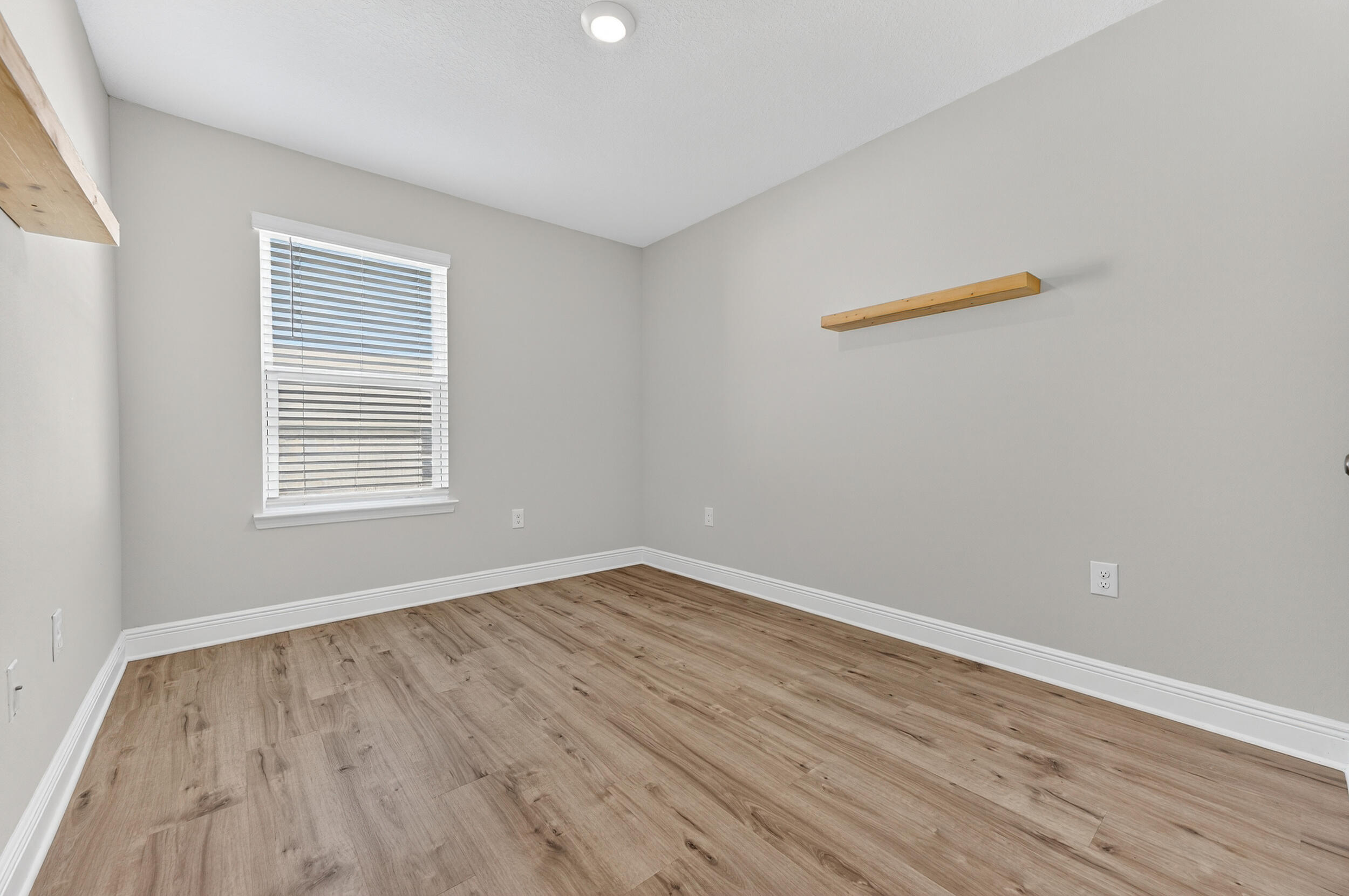 15 Redbird Loop Destin, FL 32541 - Photo 30 of 42 wooden floor in an empty room with a window
