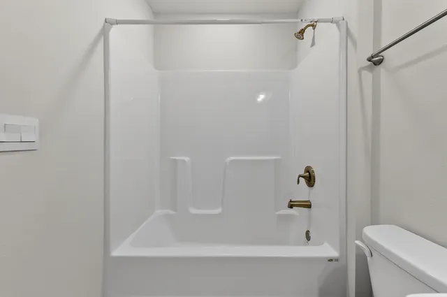 a bathroom with a bathtub and a toilet
