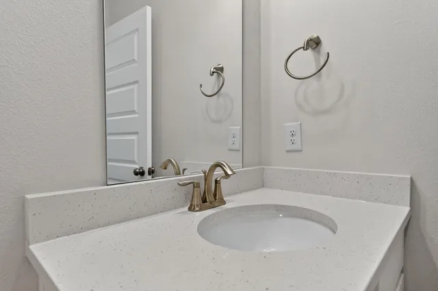 a bathroom with a tub sink and mirror