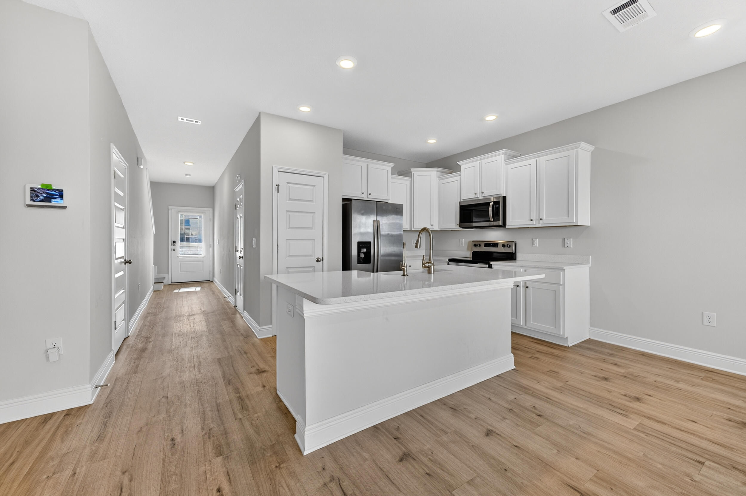 15 Redbird Loop Destin, FL 32541 - Photo 5 of 42 a view of a kitchen with cabinets stainless steel appliances a sink and a refrigerator