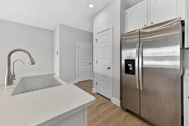 a kitchen with a refrigerator and a sink
