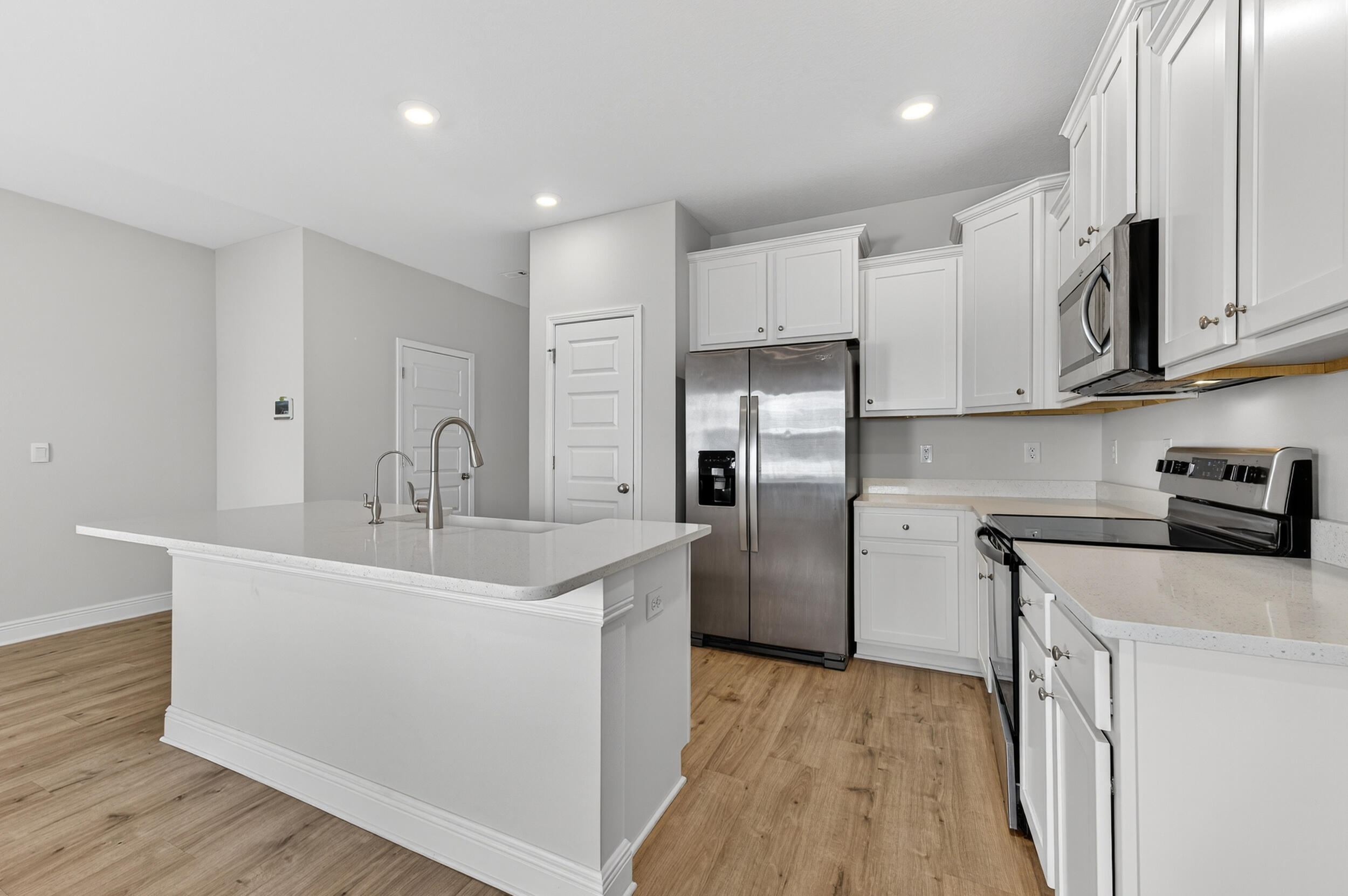 15 Redbird Loop Destin, FL 32541 - Photo 10 of 42 a kitchen with stainless steel appliances a sink dishwasher a refrigerator and a stove with wooden floor