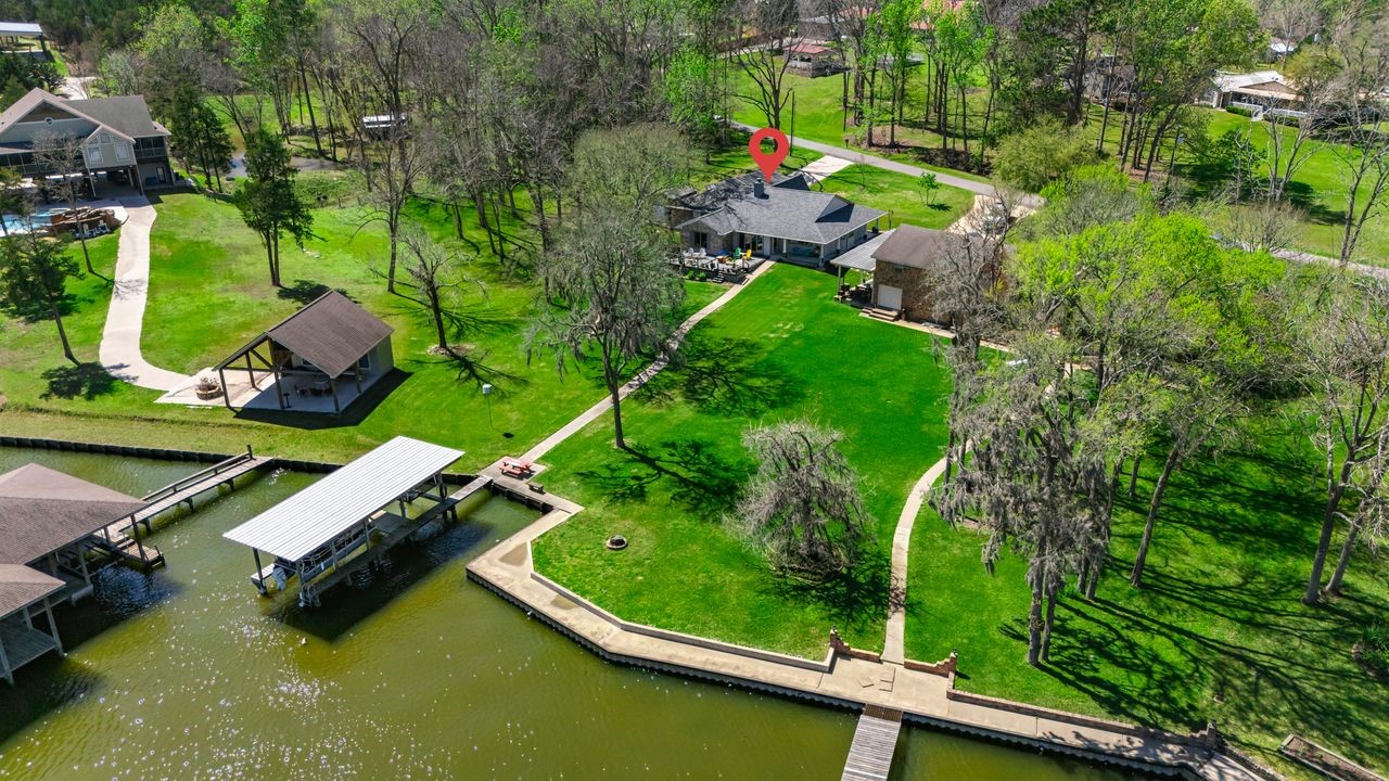 310 Cove Loop Coldspring, TX 77331 - Photo 40 of 48 Waterfront with a boat house. Note: pontoon boat conveys with home.
