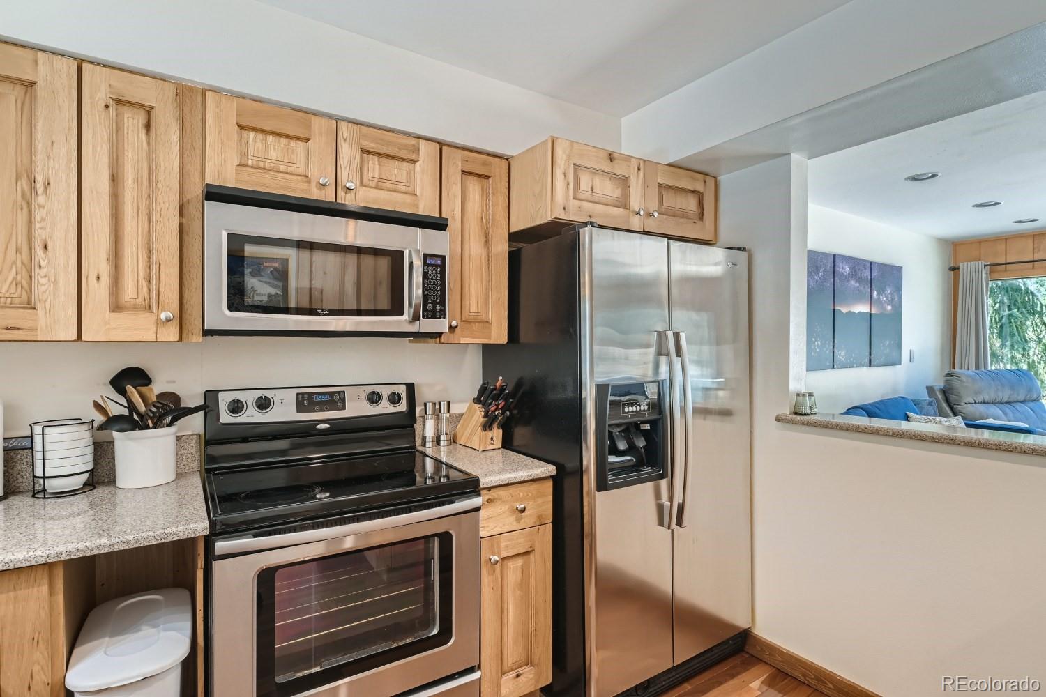 1904 Soda Ridge Road, Unit 1233 Keystone, CO 80435 - Photo 5 of 29 a kitchen with stainless steel appliances granite countertop a refrigerator stove and microwave