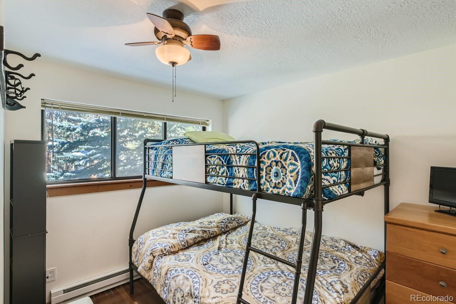 1904 Soda Ridge Road, Unit 1233 Keystone, CO 80435 - Photo 9 of 29 a bedroom with a bed and a dresser