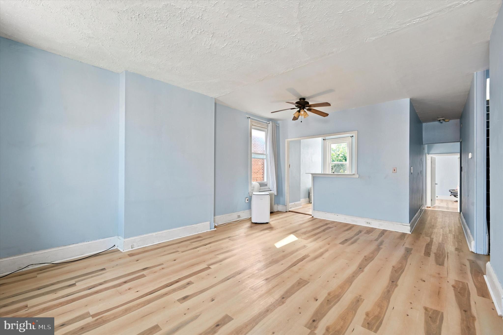 204 Ripka Street, Unit 2 Philadelphia, PA 19127 - Photo 3 of 22 a view of an empty room with wooden floor and a window