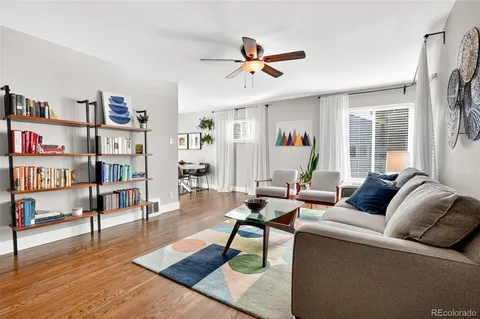 a living room with furniture and a book shelf
