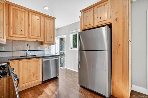 a living room with furniture a flat screen tv and a large window