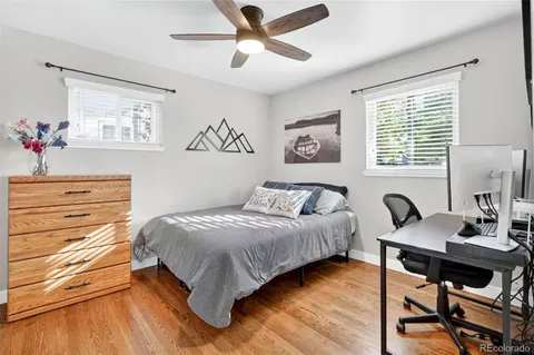 a view of a patio with table and chairs with wooden fence