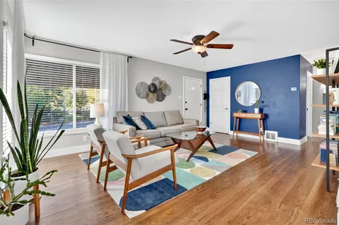 a front view of a house with a yard and tree s