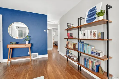 a view of a dining room with furniture and wooden floor