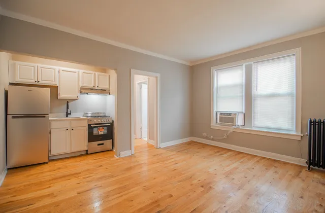 a kitchen with granite countertop a refrigerator sink and cabinets