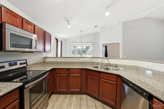 a kitchen with a sink stove and microwave