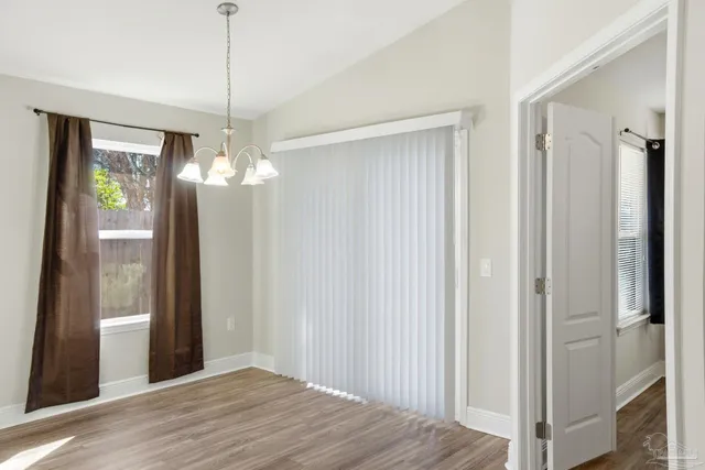 a view of a chandelier in big room and hallway