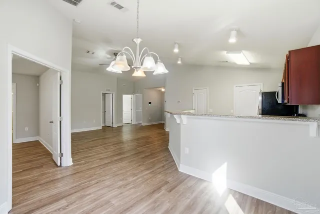 a view of a kitchen with a sink and wooden floor