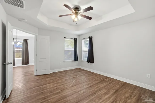 wooden floor in an empty room with a window