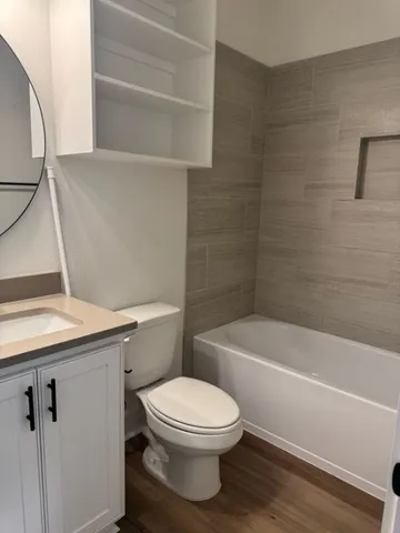a bathroom with a toilet a sink and bathtub
