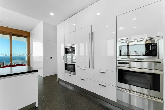 a kitchen with stainless steel appliances a refrigerator stove and microwave