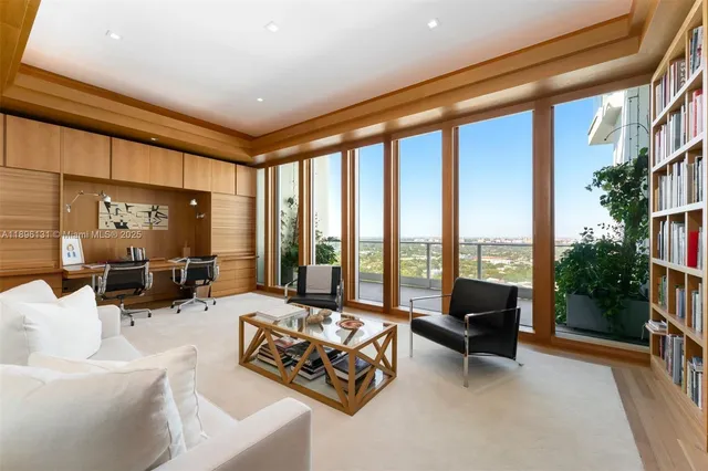a living room with furniture and a floor to ceiling window
