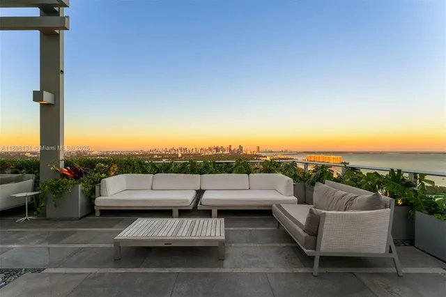 a view of a roof deck with couches and potted plants