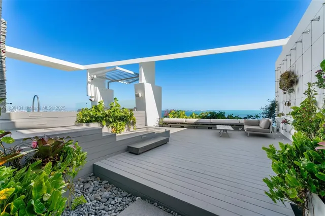 a view of a patio with couches and potted plants