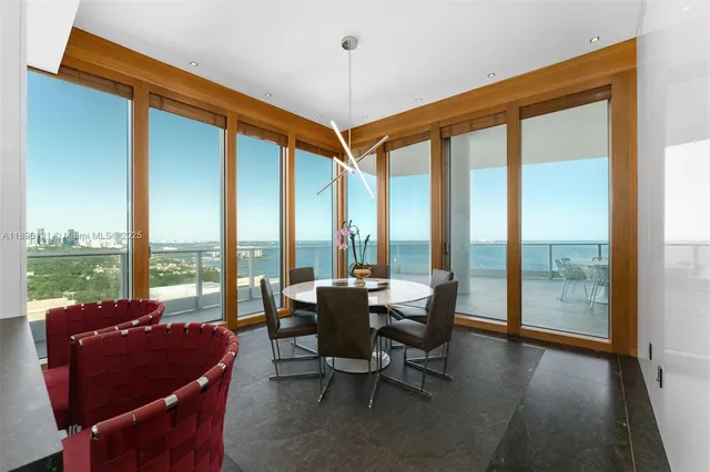 a living room with furniture and floor to ceiling windows