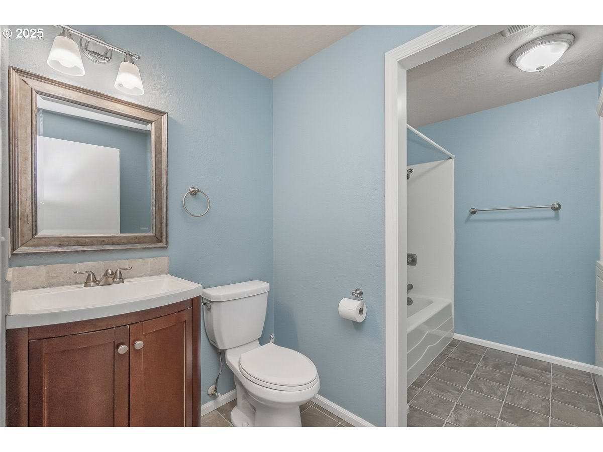 3247 Southeast Hathaway Drive Corvallis, OR 97333 - Photo 16 of 28 a bathroom with a toilet sink vanity and mirror