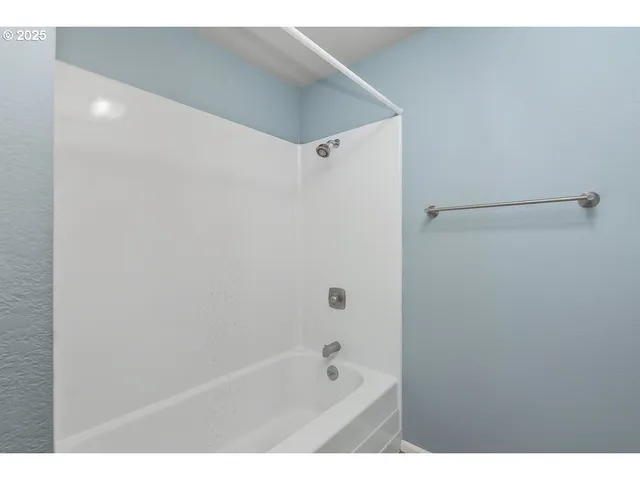 a bathroom with a bathtub and shower