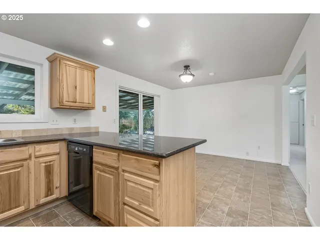 a kitchen with granite countertop a sink and a stove
