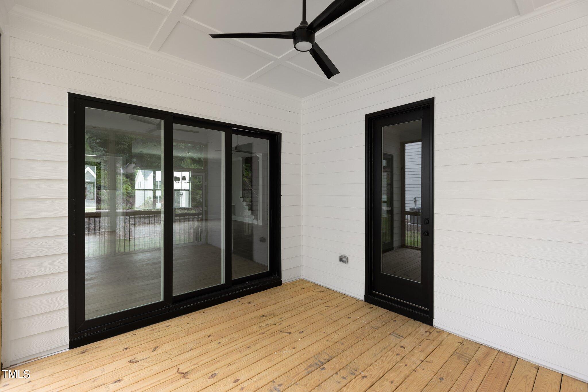 9313 Field Maple Court Raleigh, NC 27613 - Photo 50 of 53 a view of empty room with wooden floor and fan